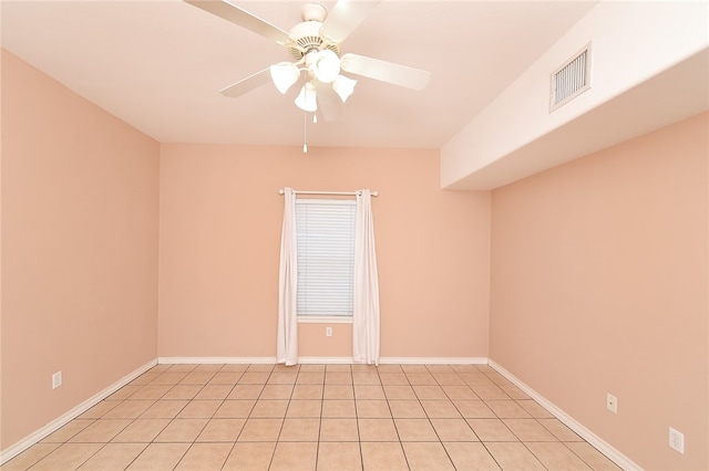 spare room featuring ceiling fan and light tile patterned floors