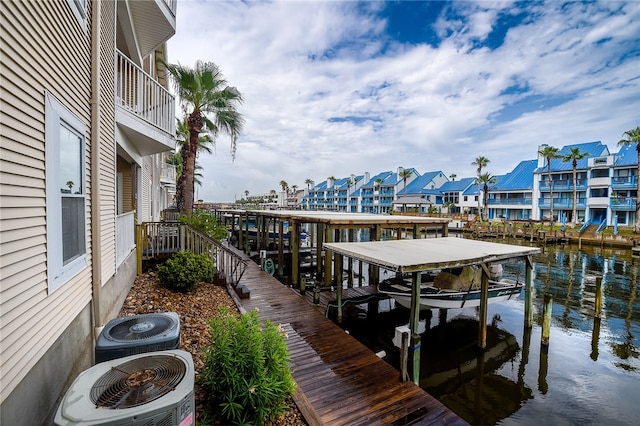 dock area featuring a balcony, central AC unit, and a water view