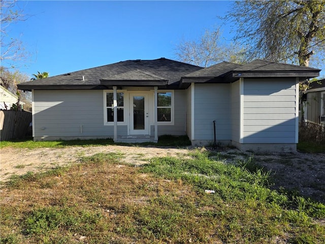 back of house featuring a yard and fence