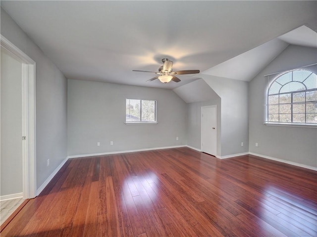 bonus room with baseboards, wood-type flooring, lofted ceiling, and a ceiling fan