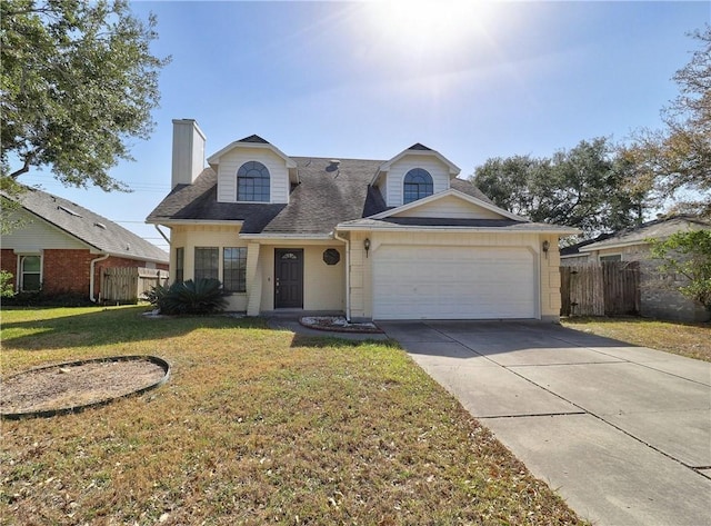 view of front of home with fence, concrete driveway, a front yard, a chimney, and an attached garage