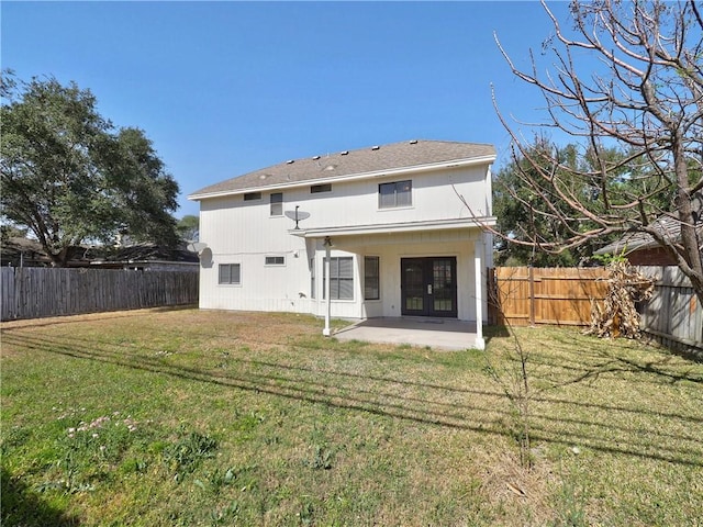 back of house featuring a fenced backyard, a patio, and a yard