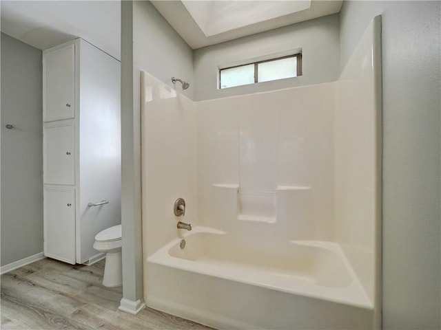 full bathroom with toilet, shower / bath combination, and wood finished floors