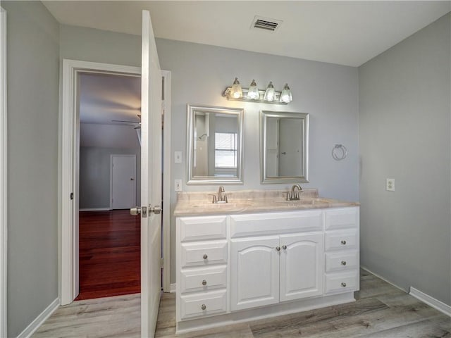 full bathroom with wood finished floors, visible vents, and a sink