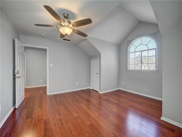 additional living space with vaulted ceiling, visible vents, baseboards, and hardwood / wood-style flooring