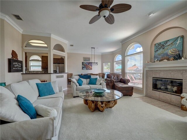 14218 Punta Bonaire Dr, Corpus Christi, TX 78418 - living room featuring a ceiling fan, ornamental molding, light carpet, and a fireplace