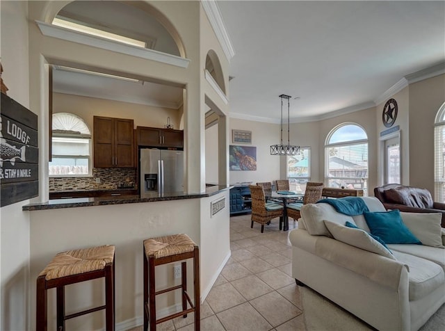 14218 Punta Bonaire Dr, Corpus Christi, TX 78418 - living area featuring crown molding, light tile patterned floors, and a chandelier