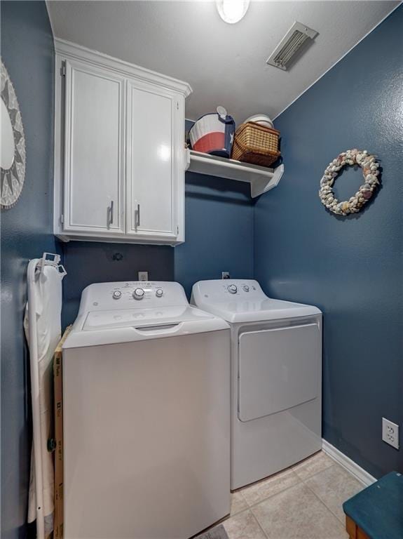 14218 Punta Bonaire Dr, Corpus Christi, TX 78418 - laundry area featuring cabinet space, washing machine and dryer, and light tile patterned flooring