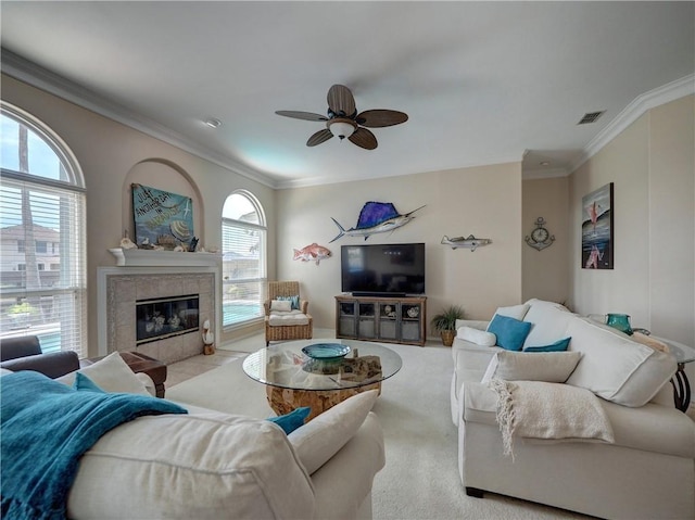 14218 Punta Bonaire Dr, Corpus Christi, TX 78418 - living room with ceiling fan, crown molding, a tile fireplace, and carpet floors