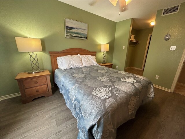 bedroom featuring ceiling fan, a closet, and light hardwood / wood-style flooring