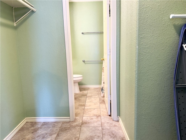 bathroom with tile patterned flooring and toilet