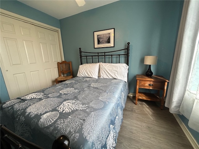 bedroom featuring hardwood / wood-style floors, a closet, and ceiling fan