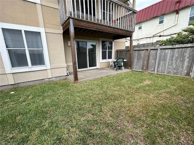 exterior space featuring a balcony, a yard, and a patio