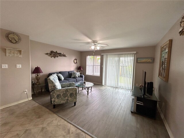 living room with ceiling fan and light hardwood / wood-style flooring