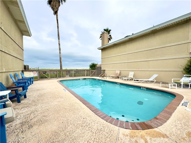 view of swimming pool with a patio area