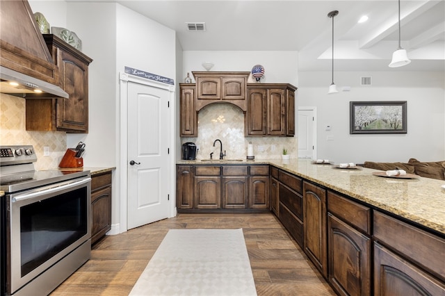 kitchen with stainless steel electric range, wood-type flooring, backsplash, decorative light fixtures, and sink