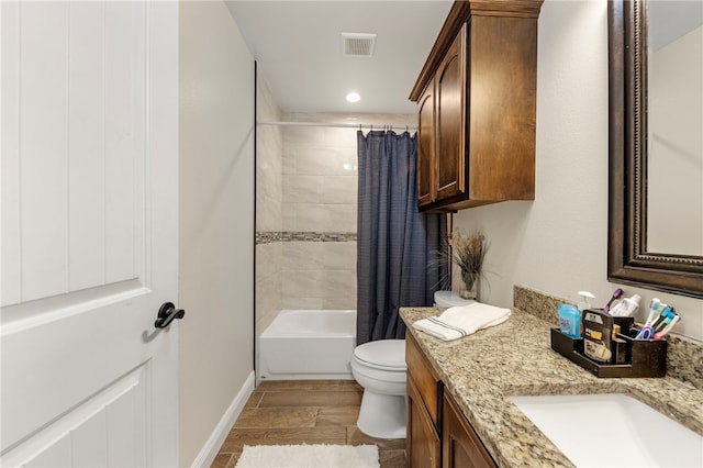 full bathroom with hardwood / wood-style floors, vanity, toilet, and shower / tub combo