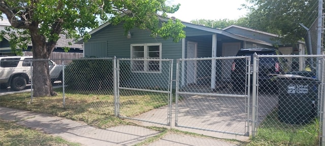 view of property exterior featuring a gate and a fenced front yard