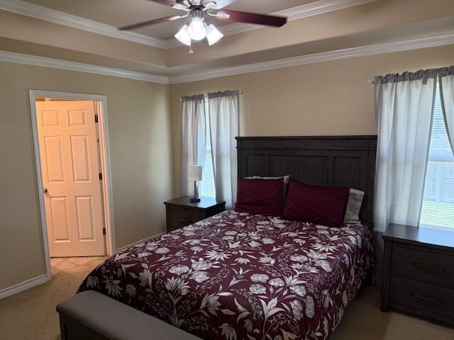 1002 Blue Crest Ln, Beeville, TX 78102 - bedroom featuring light colored carpet, crown molding, and ceiling fan
