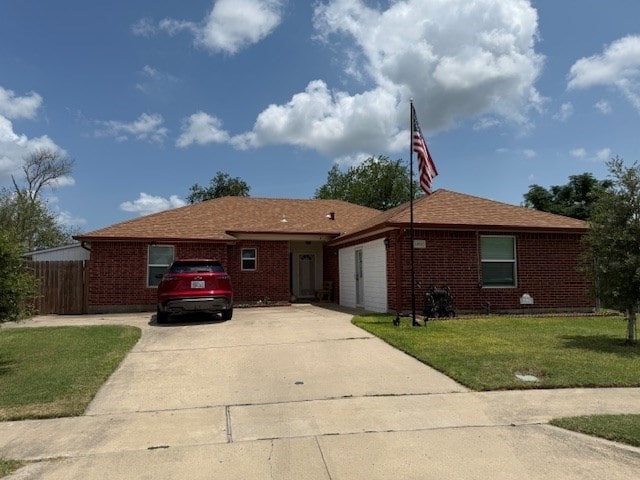 1002 Blue Crest Ln, Beeville, TX 78102 - ranch-style home with concrete driveway and brick siding
