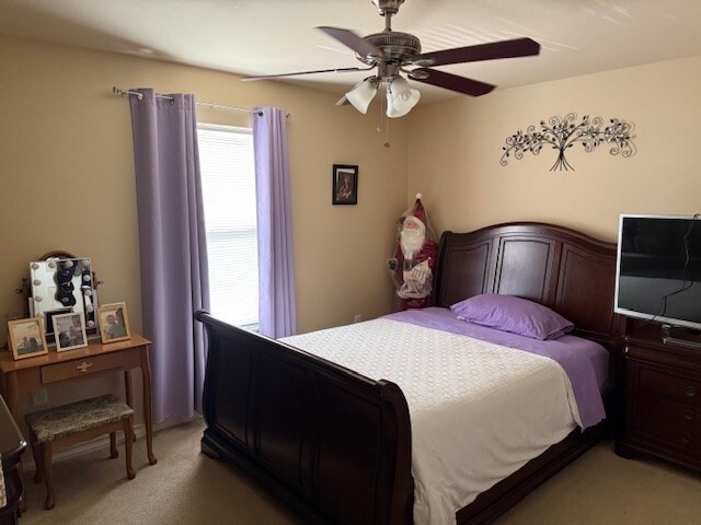 1002 Blue Crest Ln, Beeville, TX 78102 - bedroom featuring light carpet and a ceiling fan