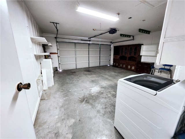 garage with a garage door opener and washer / dryer