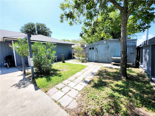 view of yard with a patio and a shed