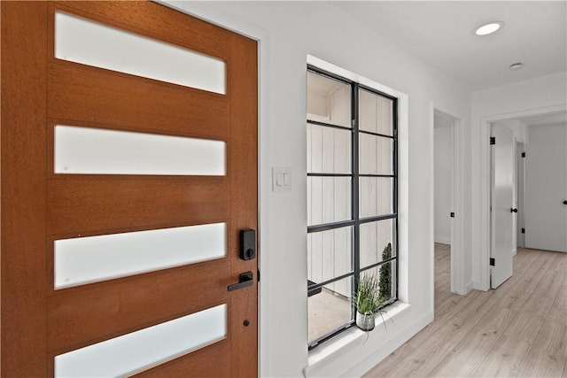 entryway with light wood-style floors, recessed lighting, and baseboards