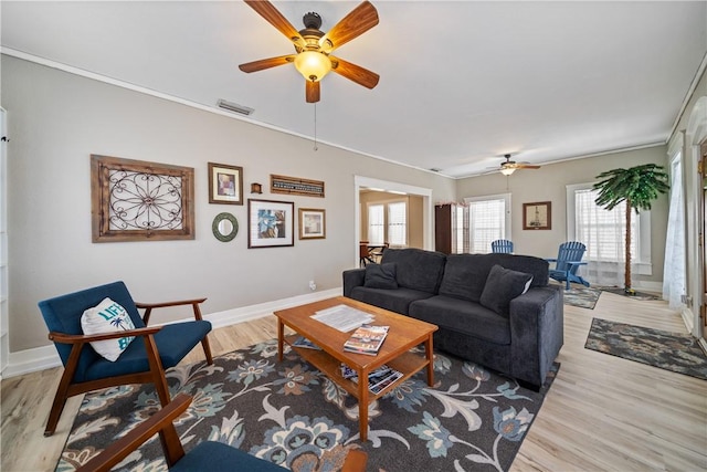 living room with ceiling fan, wood-type flooring, and ornamental molding