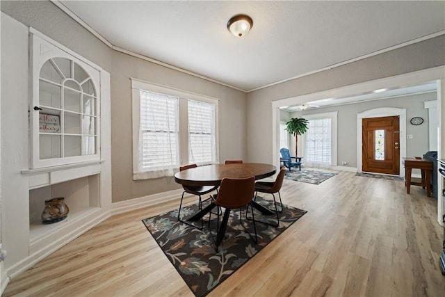 dining room with hardwood / wood-style floors, ceiling fan, and ornamental molding