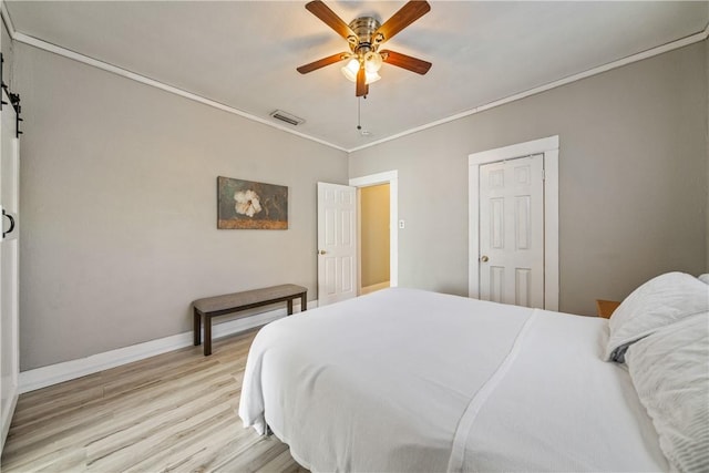 bedroom with ceiling fan, crown molding, and light wood-type flooring