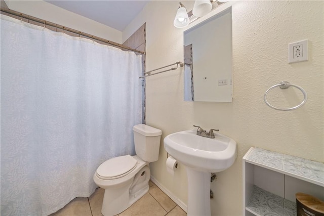 bathroom with tile patterned floors, walk in shower, and toilet