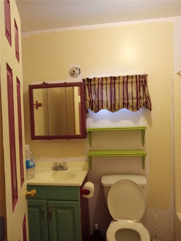 bathroom featuring toilet and vanity