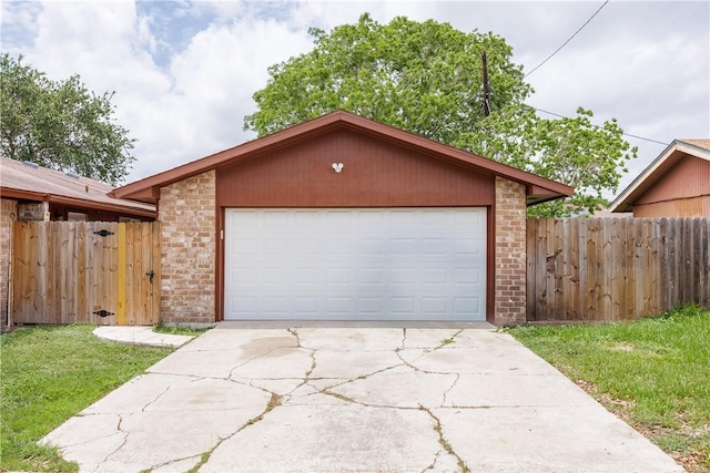 view of front of home with fence, concrete driveway, a garage, and brick siding