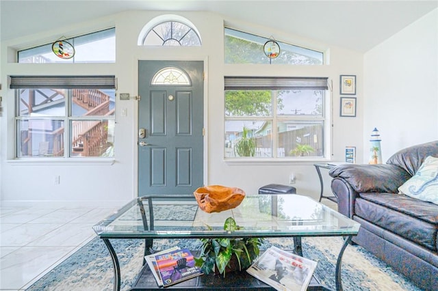 living room with vaulted ceiling and marble look tiles