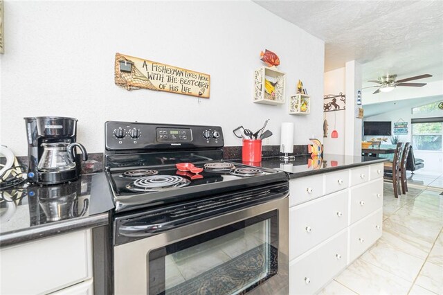 kitchen with stainless steel electric range, light marble finish flooring, white cabinetry, a ceiling fan, and dark countertops