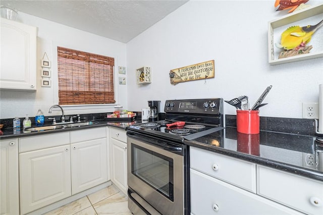 kitchen with stainless steel electric range, a sink, white cabinets, a textured ceiling, and dark stone countertops