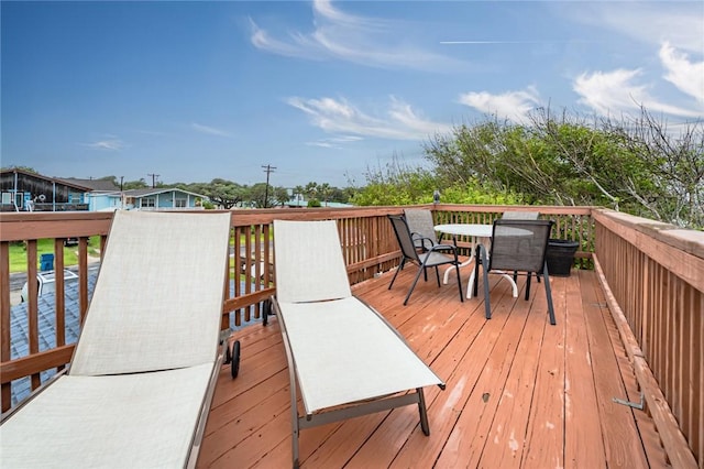 wooden terrace featuring outdoor dining area