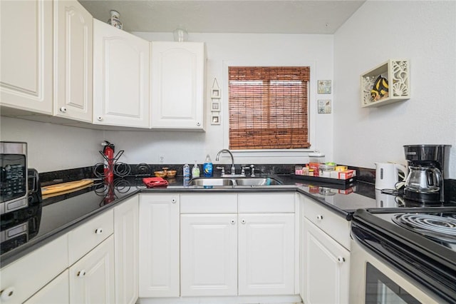 kitchen with a sink, white cabinetry, dark countertops, and stainless steel electric stove