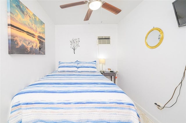 bedroom featuring a wall mounted AC and ceiling fan