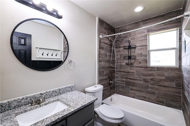 full bathroom with vanity, toilet, and tiled shower / bath