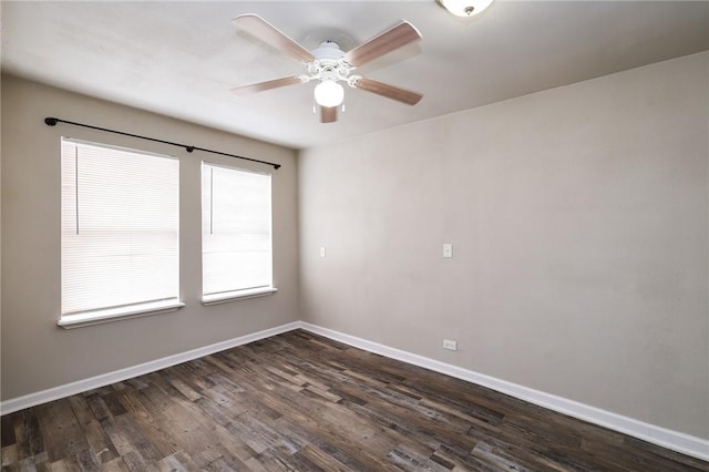 spare room featuring ceiling fan and dark wood-type flooring