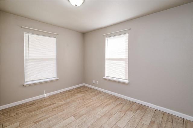 unfurnished room with light hardwood / wood-style floors