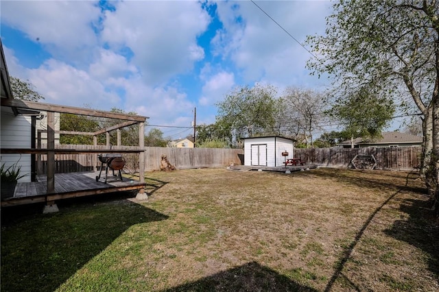 view of yard featuring a storage unit and a wooden deck