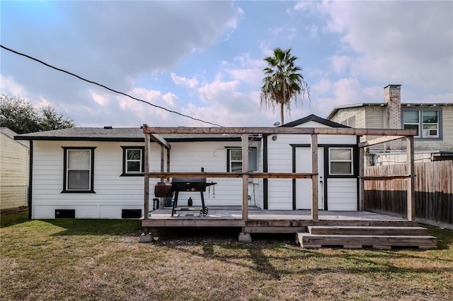 back of house with a yard and a wooden deck