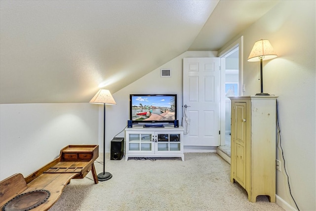 living room with light colored carpet, a textured ceiling, and lofted ceiling