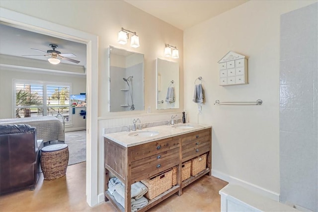 403 Marina Dr, Port Aransas, TX 78373 - full bathroom with double vanity, a ceiling fan, and baseboards