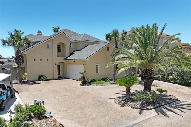 403 Marina Dr, Port Aransas, TX 78373 - view of property exterior with stucco siding, driveway, a chimney, and an attached garage