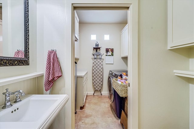 bathroom featuring sink and separate washer and dryer