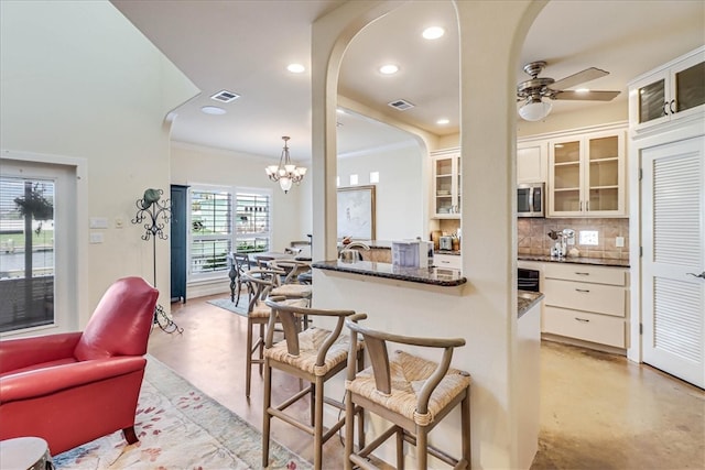 kitchen with white cabinets, decorative backsplash, and a wealth of natural light